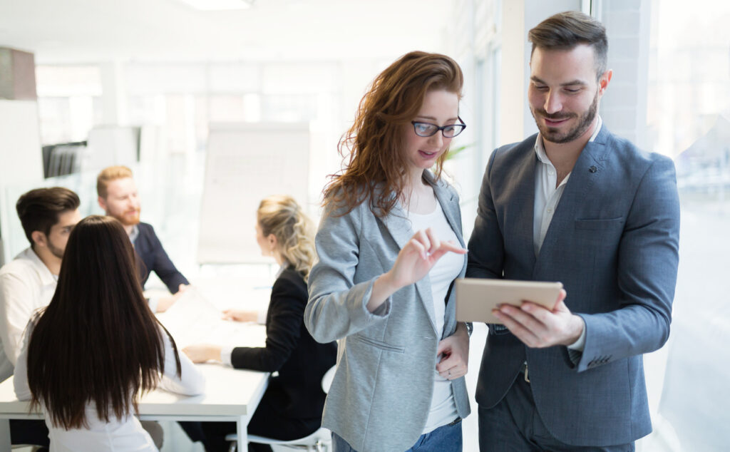 Happy collaborating business colleagues discussing future plans